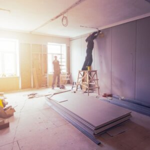 Workers are installing plasterboard (drywall) for gypsum walls in apartment is under construction, remodeling, renovation, extension, restoration and reconstruction