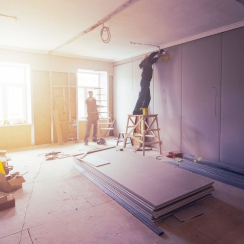 Workers are installing plasterboard (drywall) for gypsum walls in apartment is under construction, remodeling, renovation, extension, restoration and reconstruction